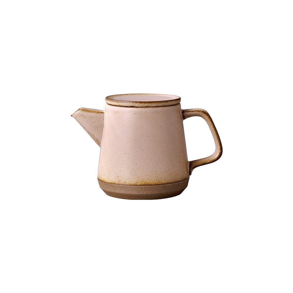 Cream-colored ceramic teapot with a short spout, round handle, and brown base rim.