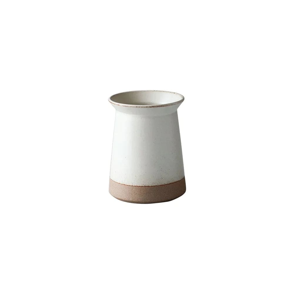 White ceramic pitcher with a brown base.