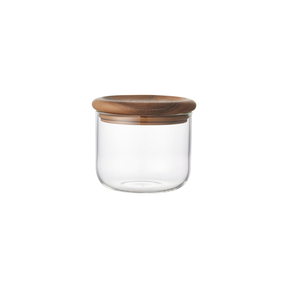 Clear glass jar with a round wooden lid, against a white background.