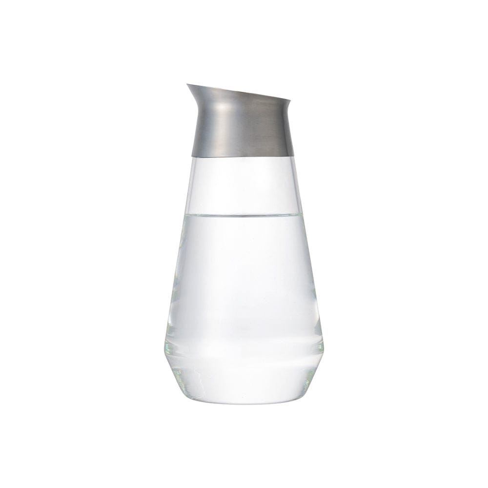 Tall glass pitcher with stainless steel lid, half-filled with water.