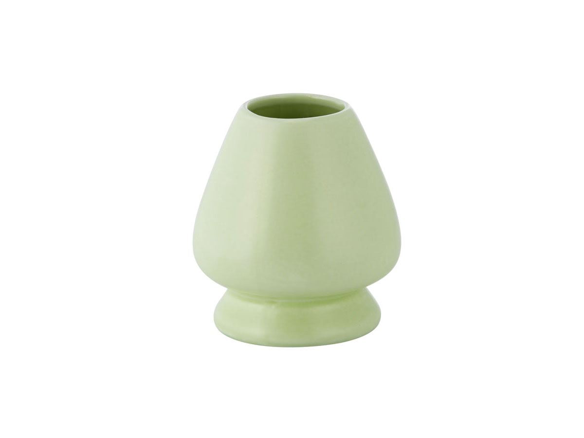 Light green ceramic whisk holder on white background.
