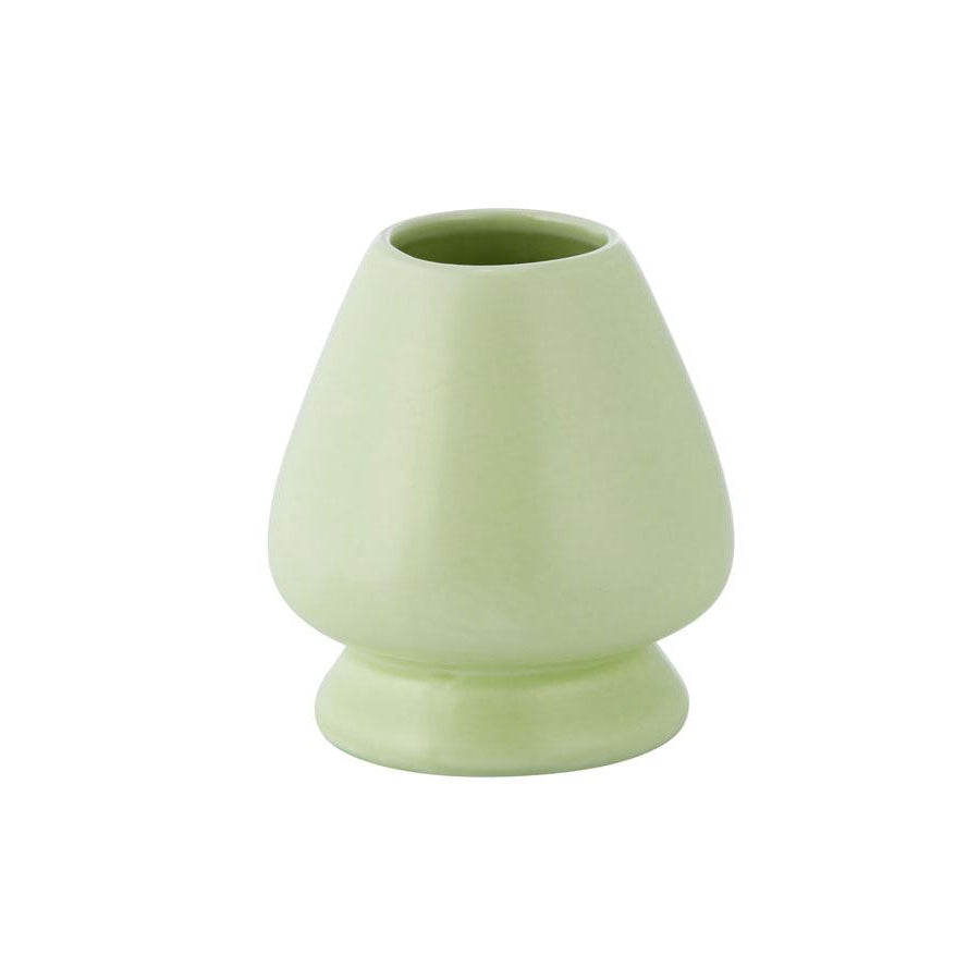 Light green ceramic whisk holder on white background.