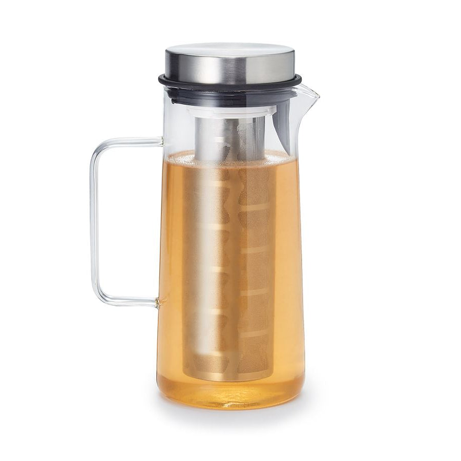 Glass pitcher with metal infuser, filled with light brown liquid.