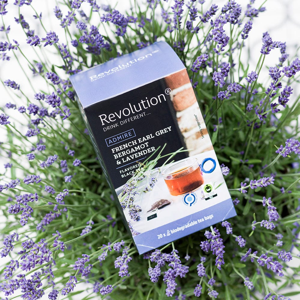 Box of French Earl Grey tea with bergamot and lavender surrounded by lavender flowers.