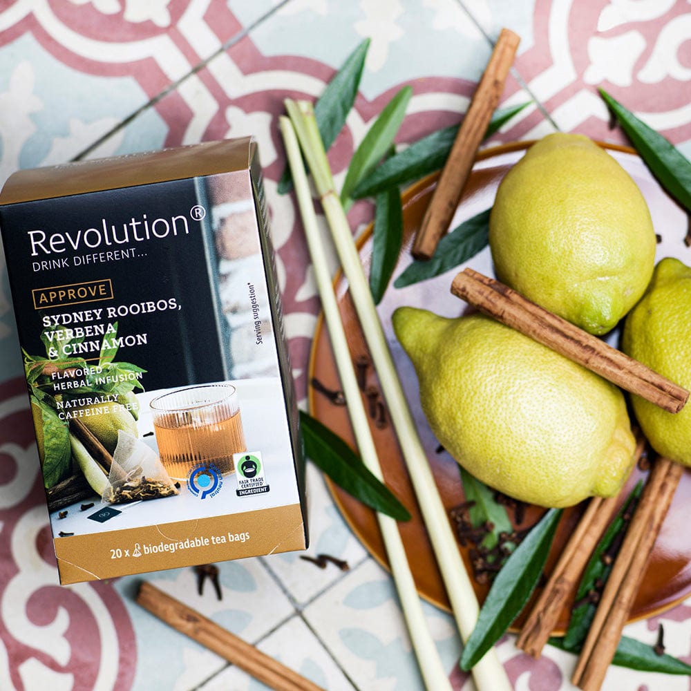 Box of Sydney Rooibos tea with verbena and cinnamon surrounded by lemons and cinnamon sticks.