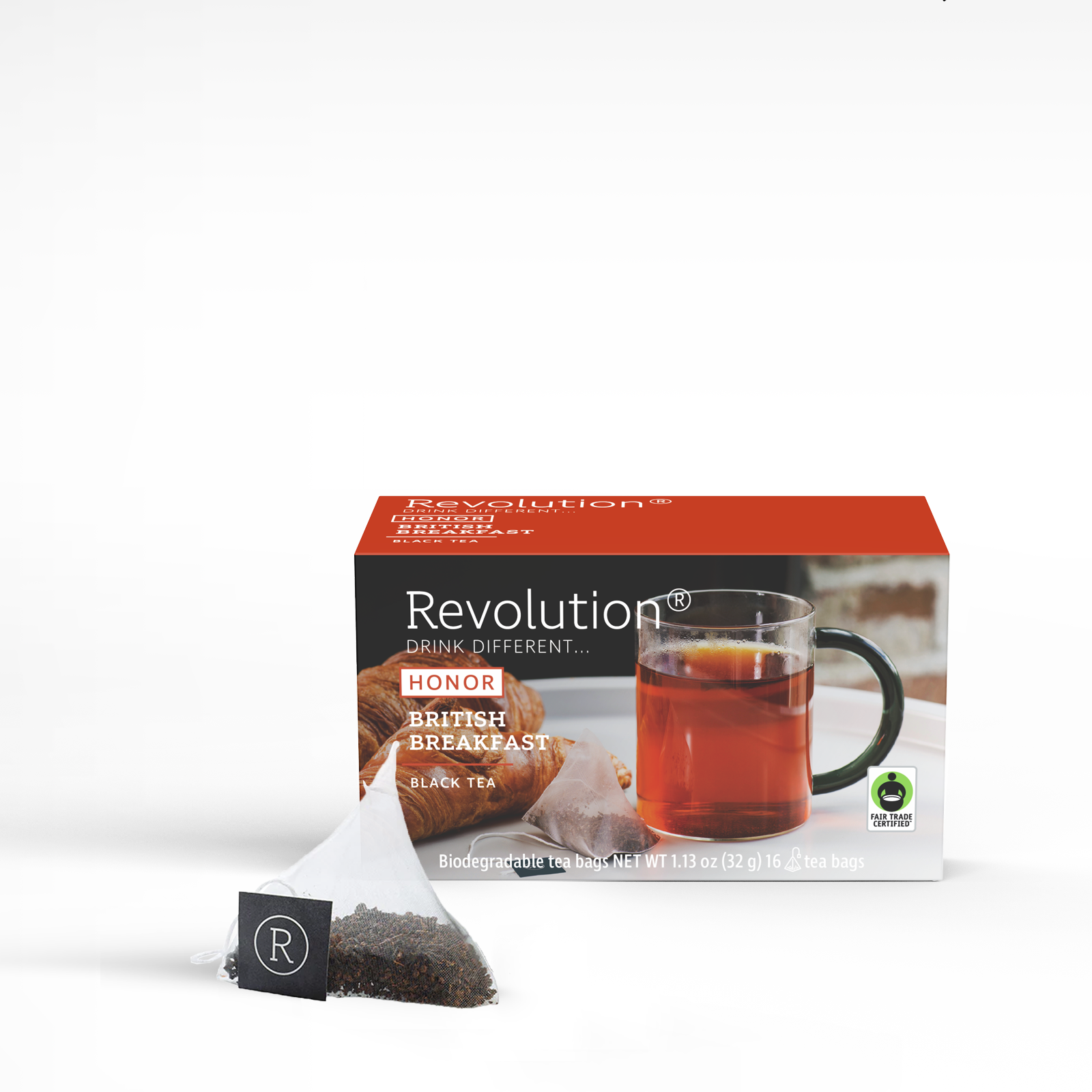 British breakfast tea box, glass cup, open tea bag with label.