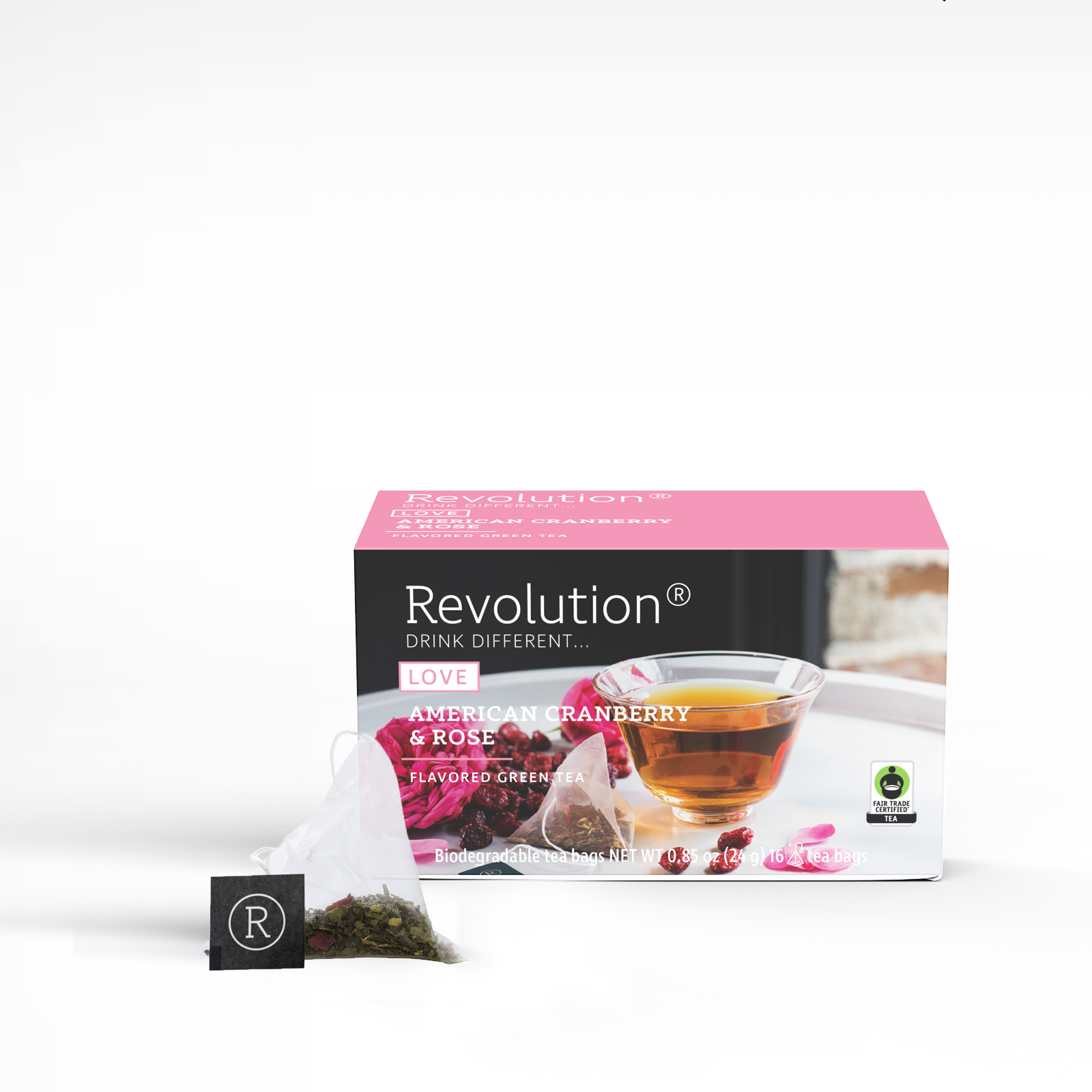 Cranberry and rose tea box, glass cup, open tea bag with label.