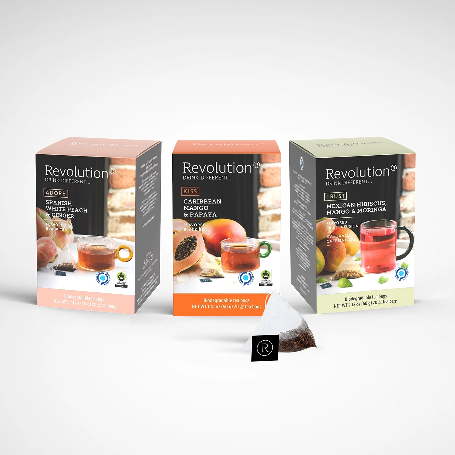 Three tea boxes with a clear tea bag, arranged on a white background.