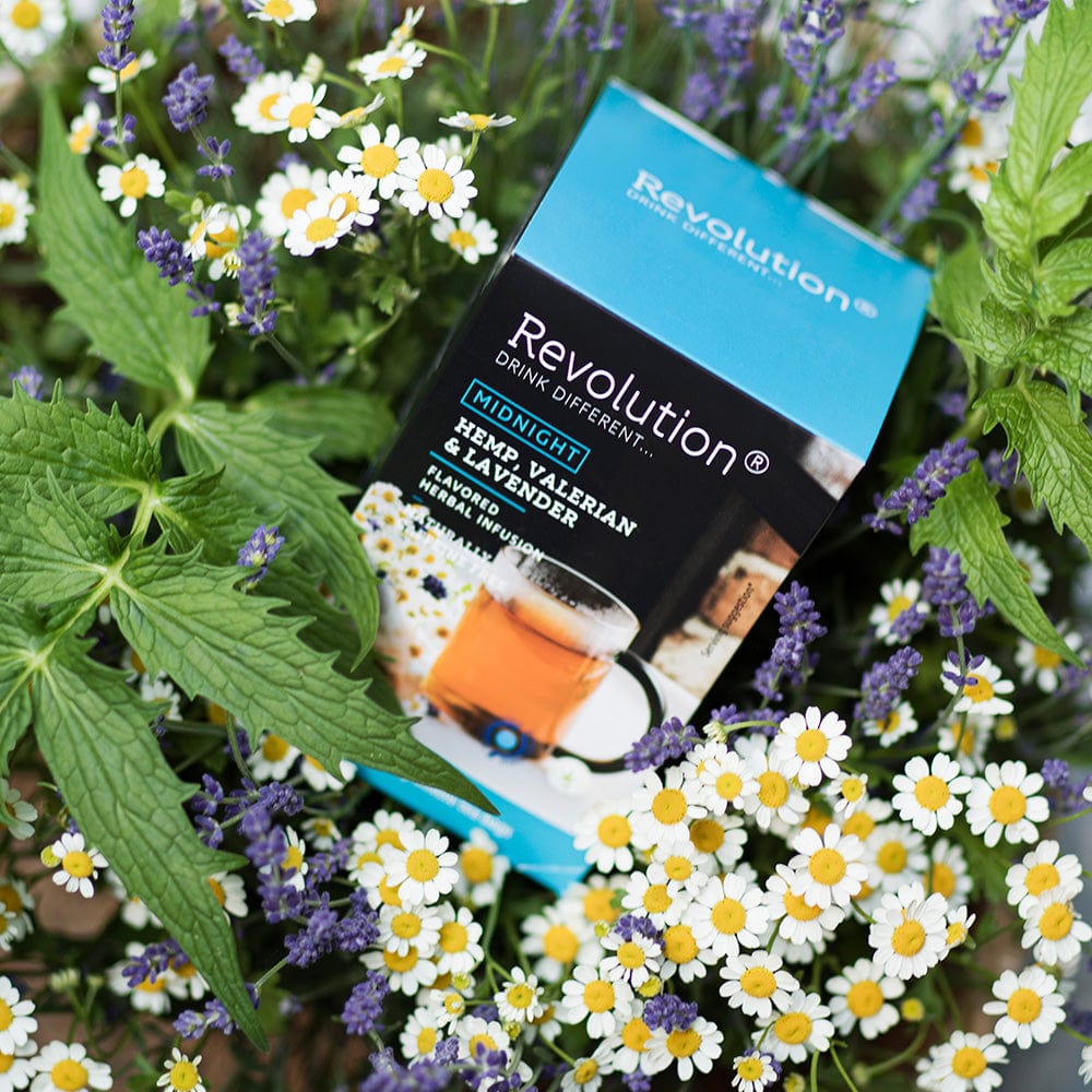 Himalayan Earl Grey and Lavender tea box amidst lavender and chamomile flowers.