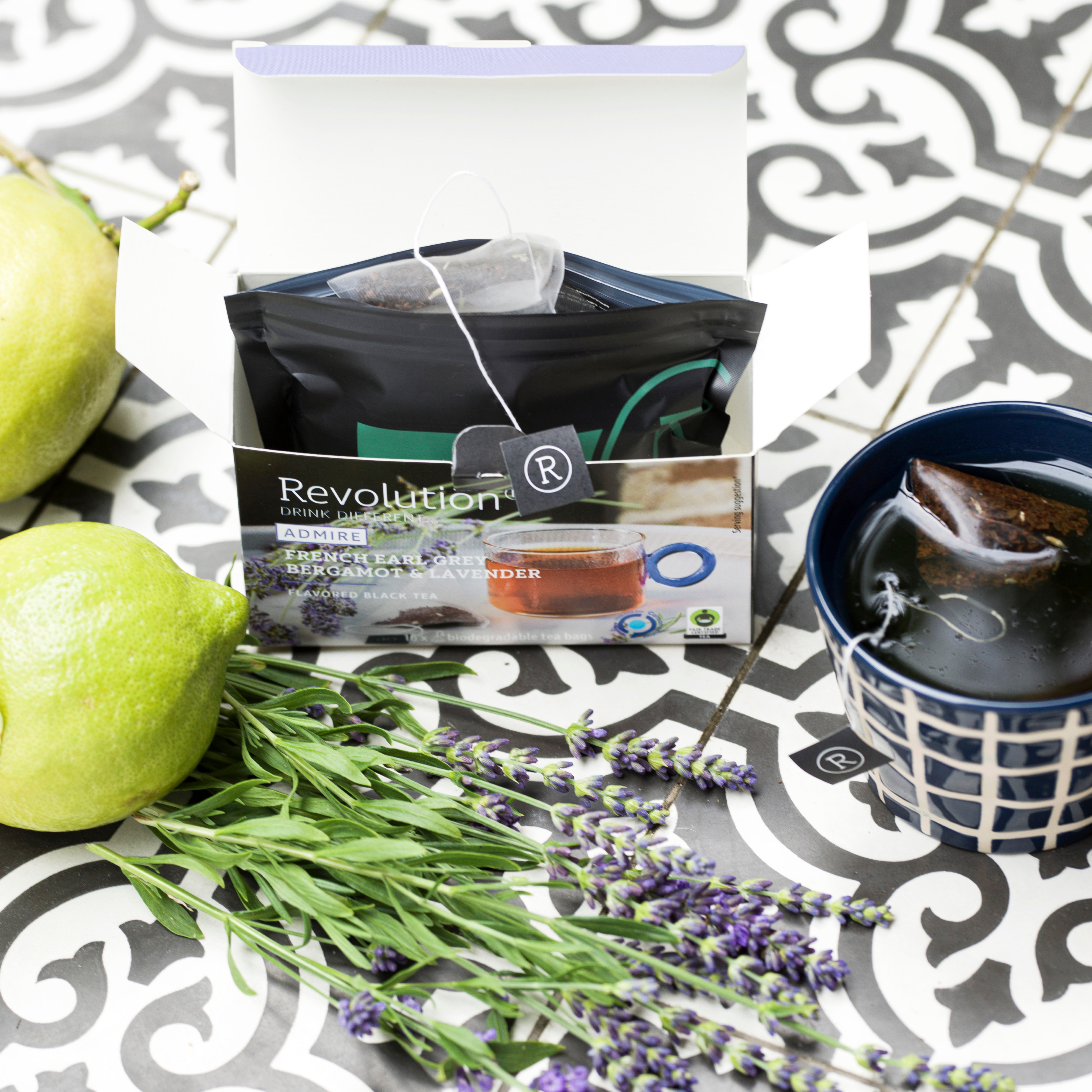 Tea box with fresh lemons, lavender sprigs, and a blue cup.