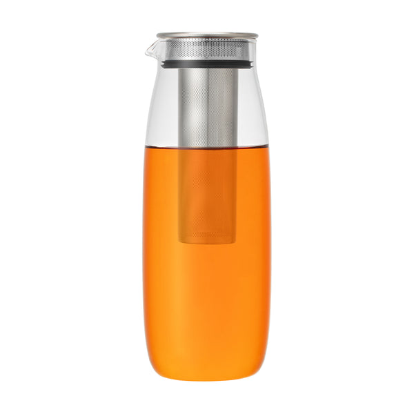 Glass pitcher filled with orange liquid, visible infuser inside, steel lid.