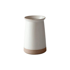White ceramic holder with a natural clay base on a white background.
