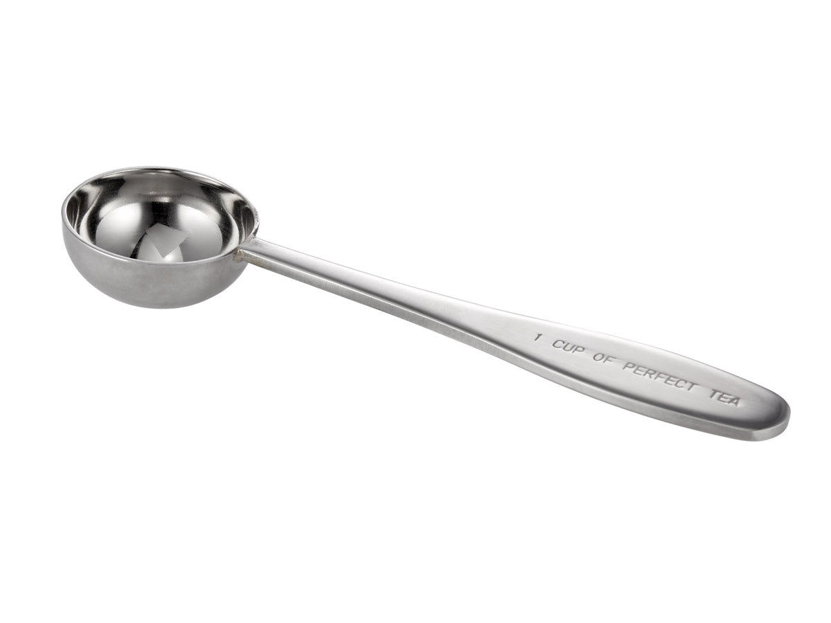 Silver measuring scoop with "1 CUP OF PERFECT TEA" engraved on handle.
