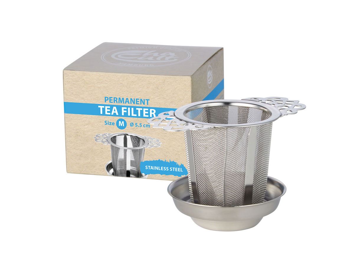 Stainless steel tea filter with drip tray next to packaging box.