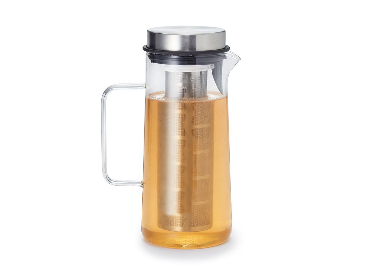Glass pitcher with metal infuser, filled with light brown liquid.