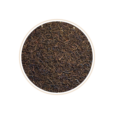 Close-up of loose dark tea leaves in a circular frame.