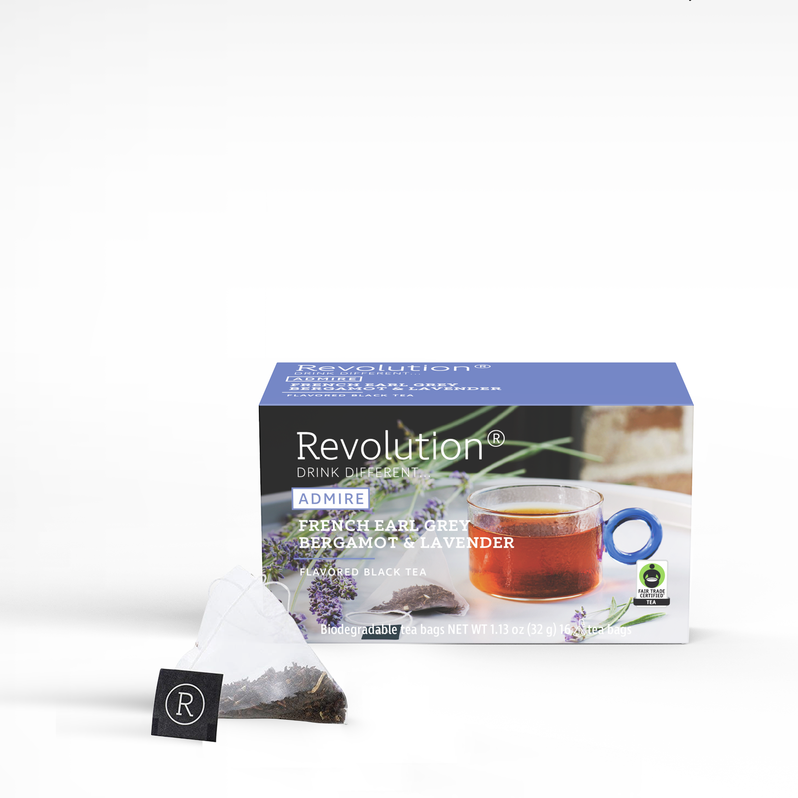 Earl grey tea box, glass cup, open tea bag with label.