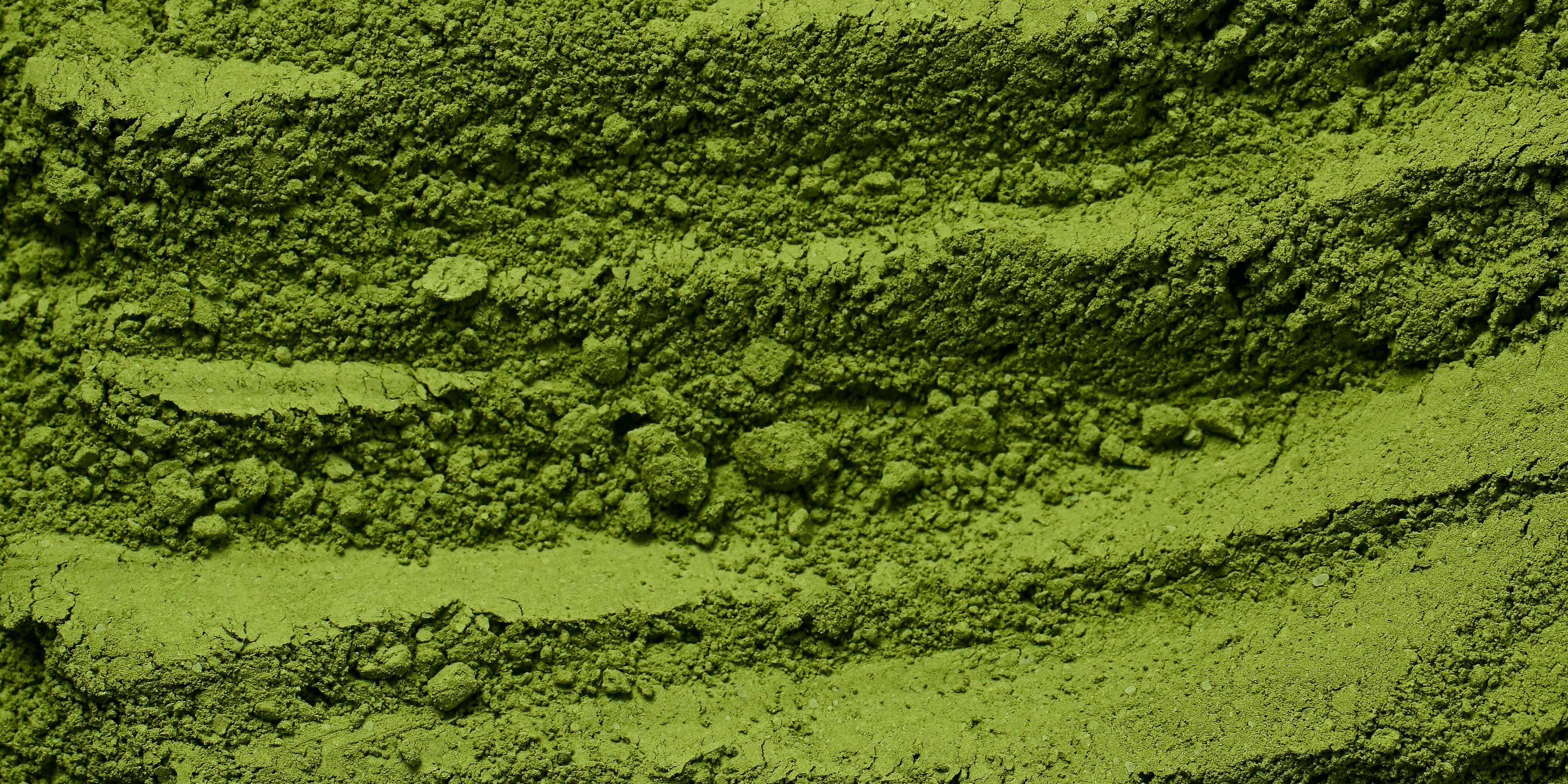 Close-up of green powder with textured, uneven surface.